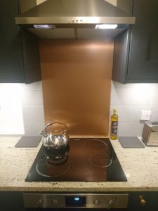 copper splashback behind hob