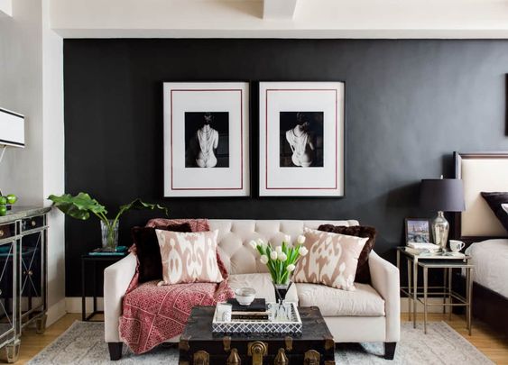 blue accent wall with white paintings