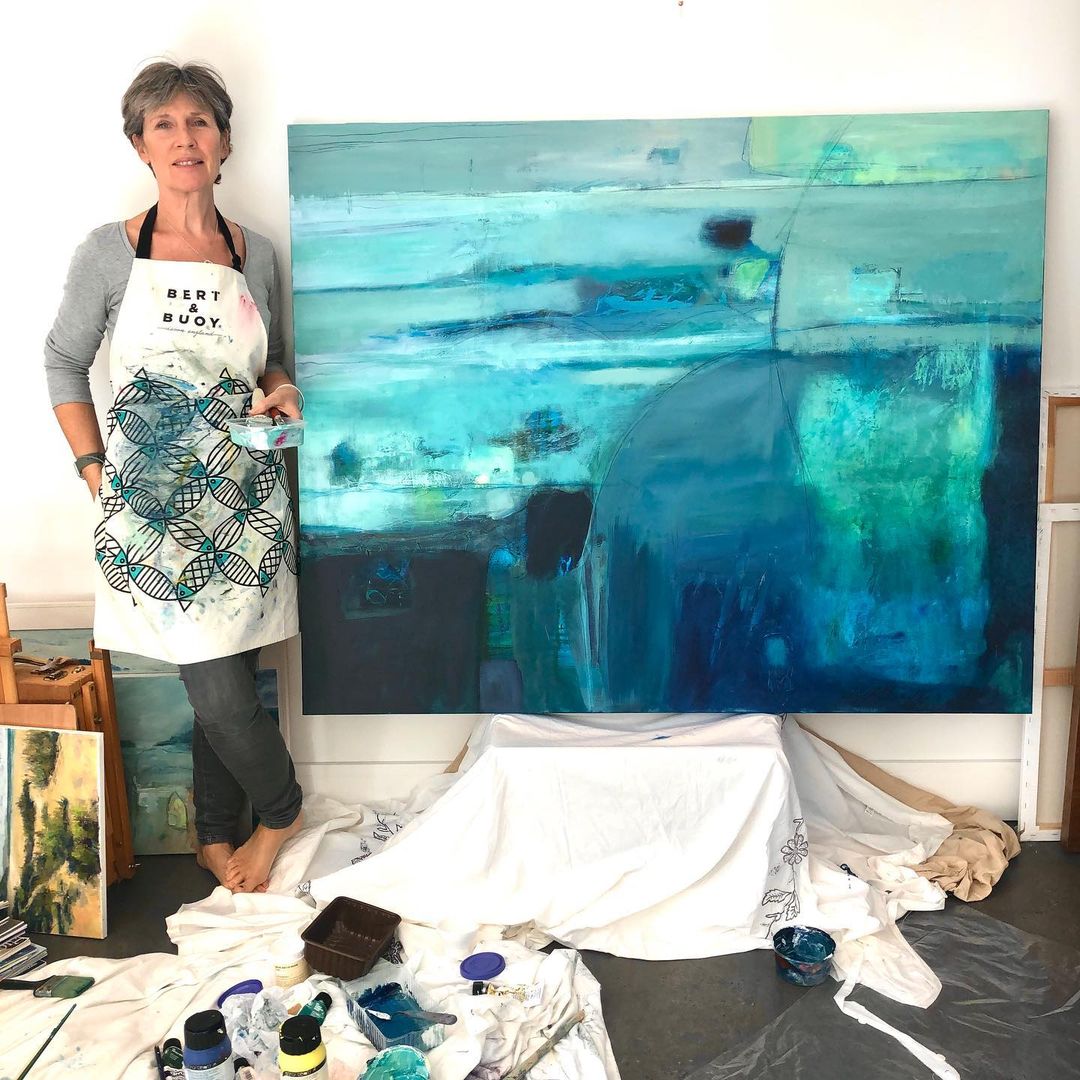 Artist Camilla Clark stood next to one of her paintings.